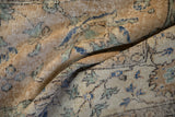 Distressed vintage Sparta carpet close-up, highlighting camel foundation, faded Herati vinery, and cobalt blue accents.