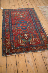 Vintage Karaja rug's sapphire starburst border and cherry red field with pinwheel blossoms.