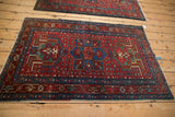 Vintage Karaja rug's corner with sapphire blue starburst border and cherry red field.