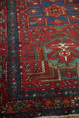 Fine Karaja rug border, sapphire blue checkered vine, and cherry red floral motifs.
