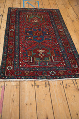 Intricate starburst plants and pinwheel motifs at the corner of a cherry red Karaja rug.