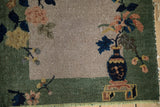 Chinese Nichols Art Deco rug detail: dark cobalt blue vase, ornate blush florals, celadon green border.