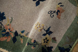 Antique Nichols Art Deco rug pile displaying muted floral motifs and scattered white knots.