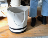 A large cotton rope storage basket with handles shown in a studio setting.