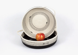 A cream one-handled cotton rope basket sits inside a black basket, displaying contrasting coiled interiors.
