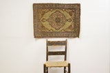 Antique Persian Kerman rug, khaki central medallion, maroon floral motifs, soft low pile.