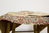 Antique Persian Kerman rug with tattered selvage, low pile, and traditional border detail.