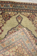 Antique Persian Kerman rug with khaki, maroon, low pile, and hand-knotted reverse.