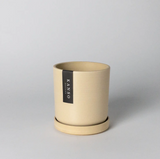 Cylindrical 4-inch recycled planter in a sand earth tone with matching saucer.