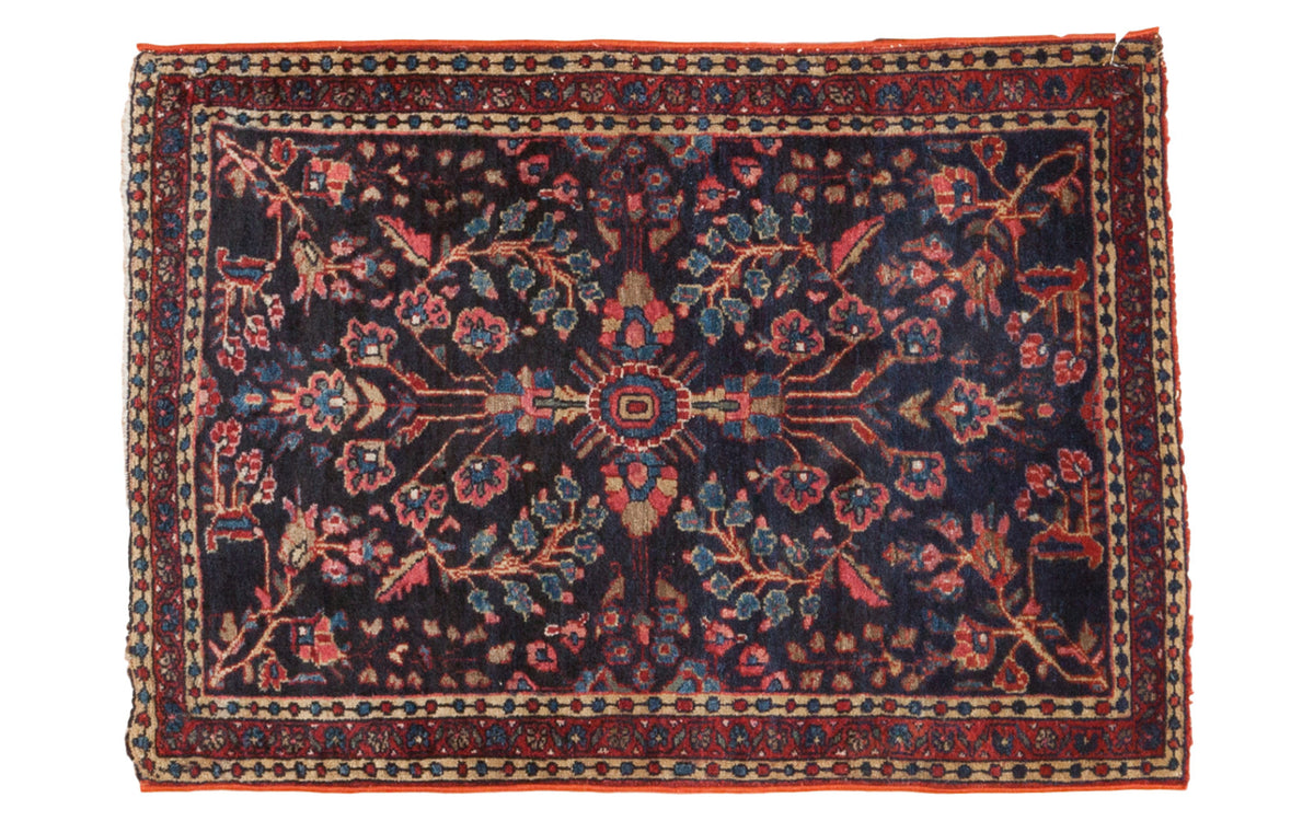 Vintage Mohajeran Sarouk rug, rare dark blue field with vibrant red, pink, and blue floral motifs.