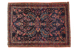 Vintage Mohajeran Sarouk rug, rare dark blue field with vibrant red, pink, and blue floral motifs.