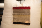Textured vintage Aguayo weaving fragment with bold red, brown, black stripes and '014' leather tag.