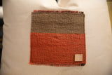 Vintage Aguayo weaving pillow features brown and orange texture, fringed edges, leather tag.