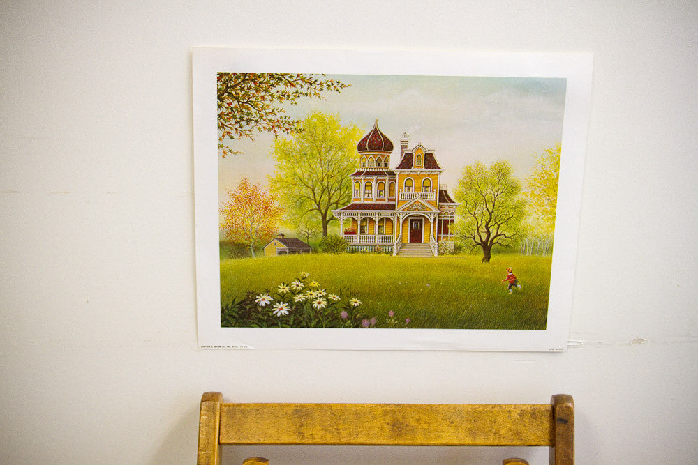 Vivid K Chin vintage lithograph depicting an ornate yellow house, bright green lawn, and a boy in red.