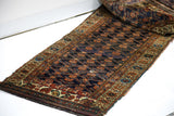 Late 19th century Kurdish tribal runner displaying dark royal blue field and intricate geometric-floral borders.