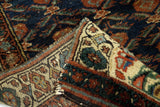 Folded Antique Kurdish wool rug displaying royal navy blue field, natural dyes, and geometric border.