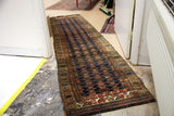 Long Kurdish tribal runner in dark navy blue with antique patterns and natural dyes.
