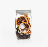 Clear jar of Camp Craft Tomatillo Sour mix, with visible dried citrus and cranberries.