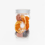 Camp Craft Cocktail Old Fashioned jar, featuring dried orange slices, dark cherries, and reddish sugar.