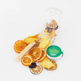 FloRita cocktail kit with dried orange, pineapple, lime, hibiscus in clear jar.