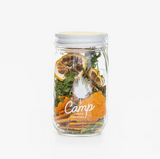 Camp Craft Bloody Mary cocktail kit with dried lemon slices, green herbs, and orange chips.