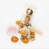 Camp Craft Cocktail Lavender Lemonade kit with dried orange slices, lavender, and sugar stick.