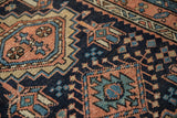 Low pile and visible knot heads of a vintage Karaja rug's geometric design.