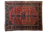 Vintage Persian Lilihan carpet in raspberry red and navy blue with a central tree of life design.