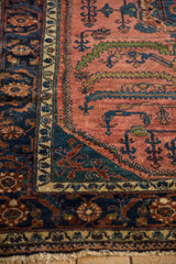 Angled view of a fine Lilihan rug's navy floral border and corner spandrel design.
