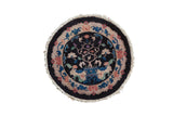 Vintage Nichols Art Deco round rug with a potted tree of life on a jet black field and a sand-toned floral border.