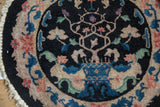 Art Deco tree of life motif with stylized vines in blue, green, and rose on a black field.