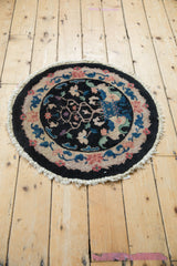 A full overhead view of the round Art Deco rug's tree of life design.