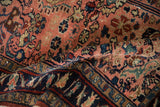 Detailed texture of hand-knotted vintage Lilihan rug, showing blush field and navy arabesques.