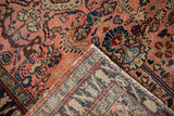 Vintage Lilihan rug corner displays tattered edge and intricate hand-knotted foundation.