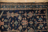 Asymmetric geometric blossoms and meandering border on antique Mehriban rug: navy, mauve, aqua.