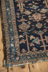 Antique Mehriban rug corner displaying a meandering border and geometric trefoil motifs.