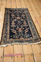 Antique Mehriban rug corner showing fringe, blue-mauve geometric border, and surfaced white knots.