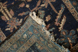 Antique Mehriban rug's dark blue pile and detailed light blue woven foundation with fringe.