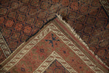 Worn pile, tattered fringe, and polychromatic plain weave on the antique Belouch rug.