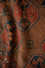 Heavily abrashed copper pile with bold tomato red and navy Ersari floral guls.