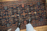 Antique Mehriban rug: navy field, germinating plant motifs, serpent borders, displaying wear.