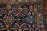 Antique Mehriban rug corner with navy field, serrated leaves, and serpent design motif.