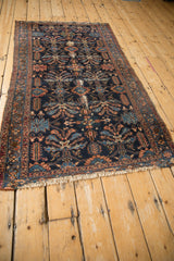 Antique Mehriban rug close-up: navy field, serrated germinating plant motifs, with mostly even wear.