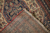 Antique Senneh rug's finely knotted pile and intricate reverse weave in navy, ivory, terracotta, and sky blue hues.