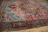 Worn vintage Heriz carpet detail, blush and sky blue field with geometric and floral motifs.