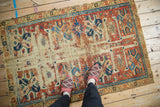Cherry red and sky blue guls, hook and latch border on worn antique Caucasian rug fragment.