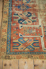 Worn cherry red guls and saffron hook border on antique Caucasian rug fragment.