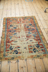 Geometric guls, cherry red, and blue motifs of antique Caucasian rug with extensive foundation wear.