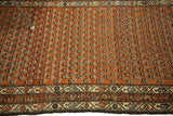 Detailed allover motifs and patterned border on a rusty red Mir Serbend Persian rug.
