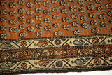 Intricate ivory border detail and allover rusty red pattern of the vintage Mir Serbend rug.